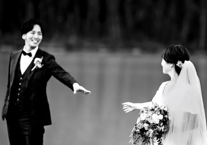 Newlyweds trying to reach each other's hands.