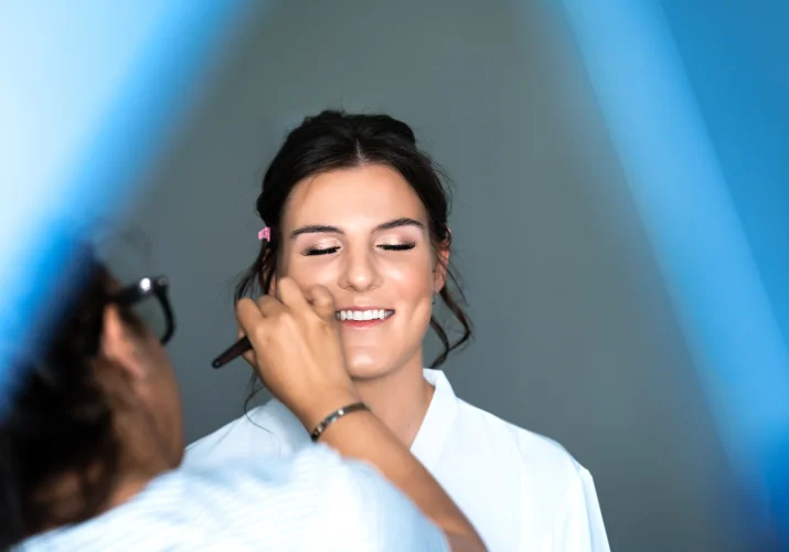 Make up artist work on the bride's make up before the Calgary Wedding Ceremony.
