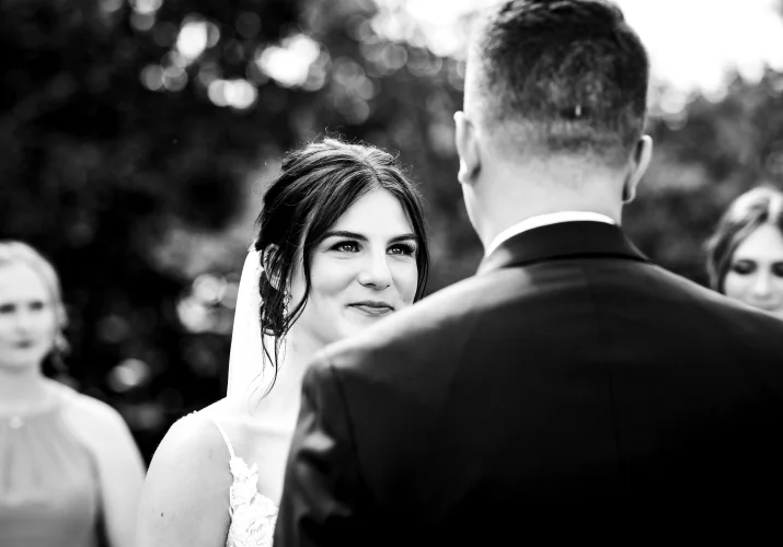 The bride look with love on the groom during touching speech at the wedding ceremony