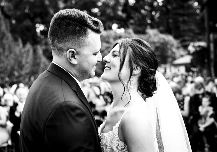 First kiss in black and white at the Calgary Wedding Ceremony.