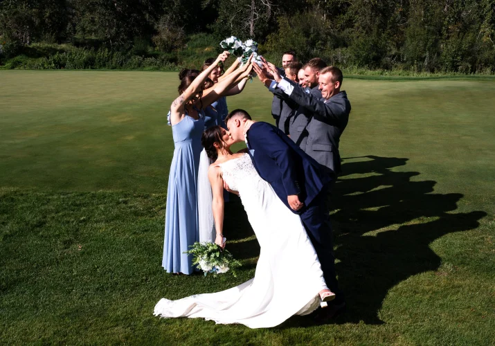 Wedding Party created a tunnel for the bride and groom. They share a kiss at the end.