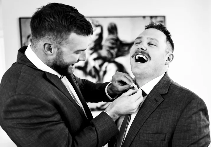 guys getting ready, dressing up and laugh before the Calgary wedding