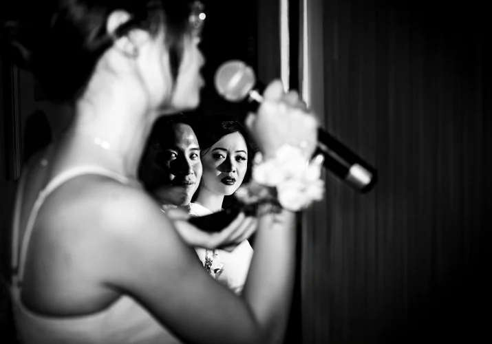 Creative Banff Wedding Photography of the bridemaid giving a speech. Photography than through her hand whit the microphone.