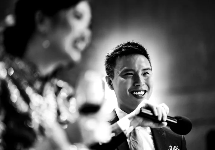 The groom speech while the bride laughs. Black and white Banff wedding photograph.