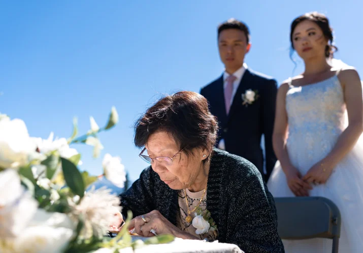 grandmother of the groom sign the banff wedding certificate. Bride and groom being her.