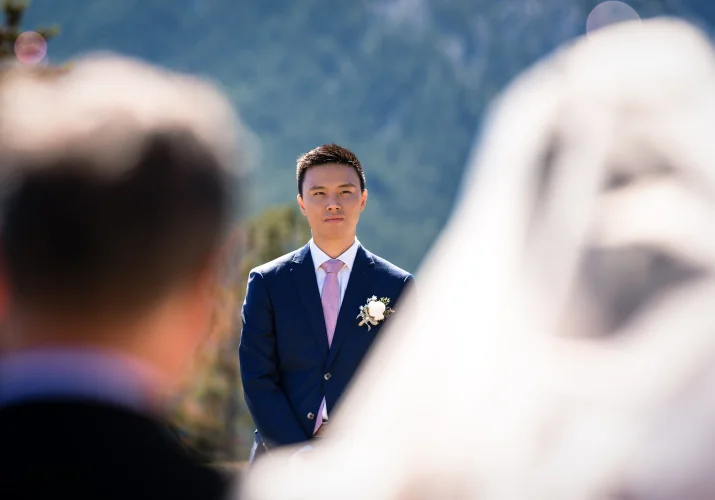 First look of the groom on the bride at the wedding ceremony in Banff.