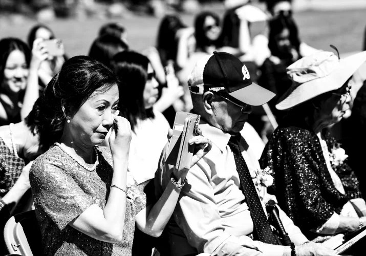 Emotional moment captured by Banff Wedding Photographer of the mother whipping her tears ot the wedding ceremony.