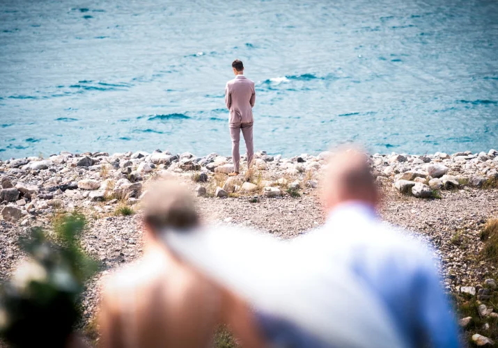 Father of the bride walks her down the aisle while the groom waiting at the lake in Banff.
