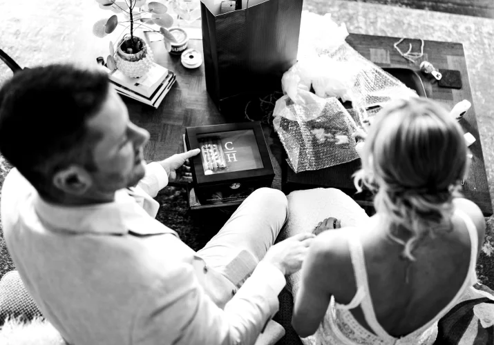 Photo taken from the above of the bride and groom while they open wedding gifts.