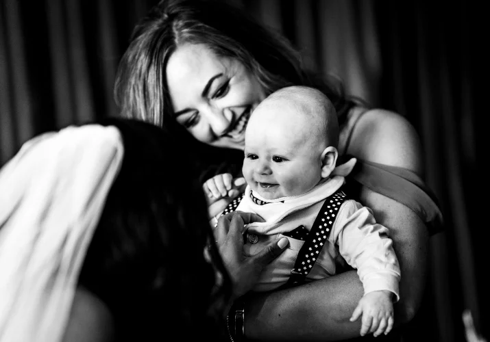 A bride plays with a baby on the Calgary Wedding