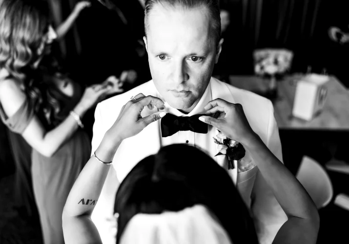 Bride is fixing the grooms tie during Calgary Wedding Day