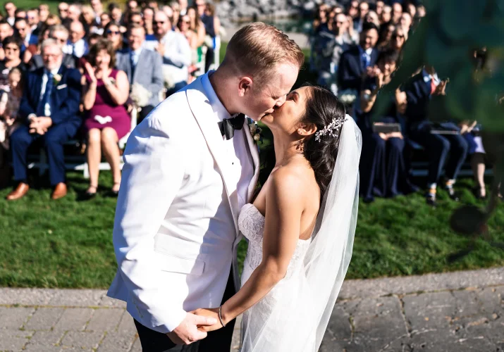 Calgary Wedding Photography of the newlyweds sharing a first kiss