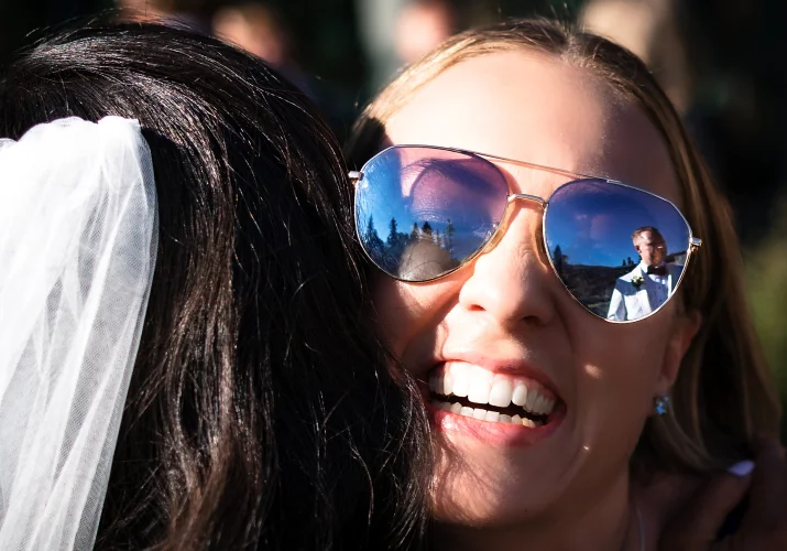 reflection of the groom in a sunglasses