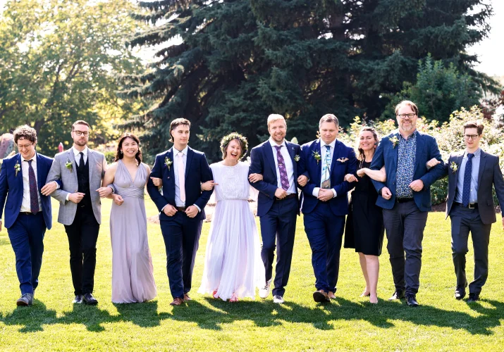 Calgary Wedding Party Photography of the wedding party walking and laughing