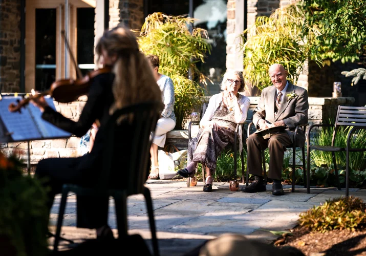 Calgary musician plays violin while grandparents of the bride listening