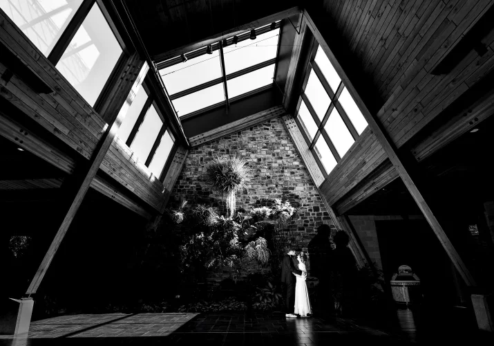 Wedding Portrait of the bride and groom in the building with huge windows in Calgary