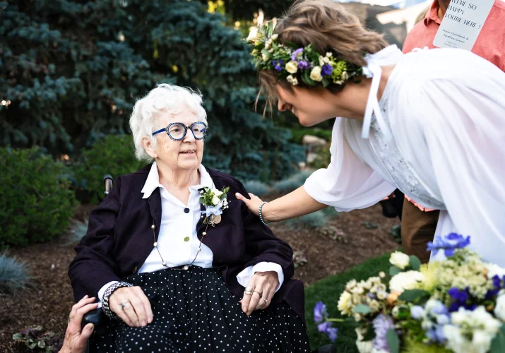 the bride put a hand on the grandmother's shoulder