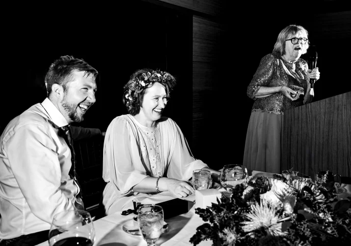 Calgary Wedding Speeches photography of the bride and groom laughing during speeches.