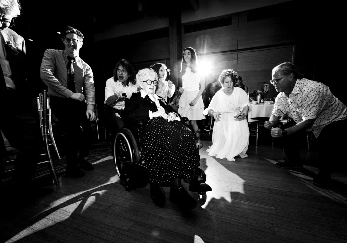 Calgary wedding dance floor photography of the bride dancing with the grandmother on the wheelchair