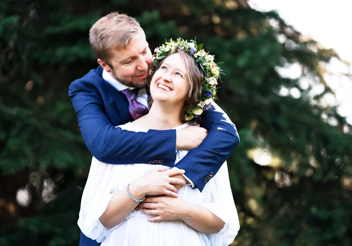 Groom hugs the bride from behind in Calgary Zoo
