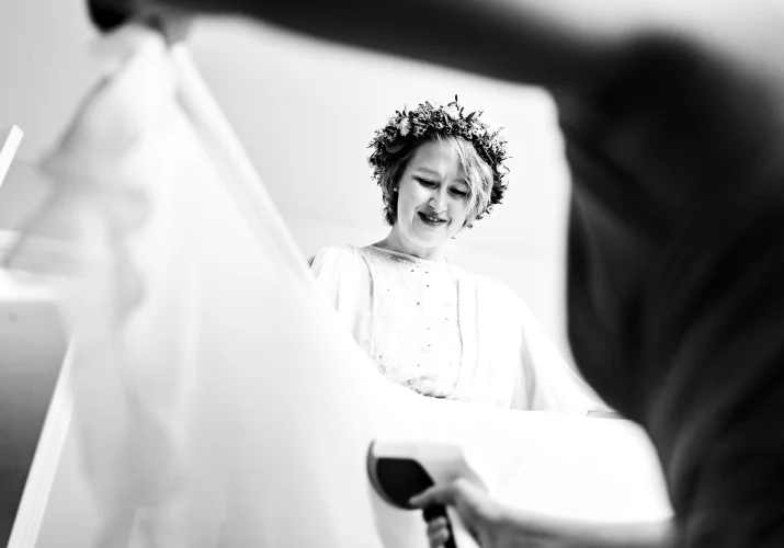maid of honour iron the bride's wedding dress