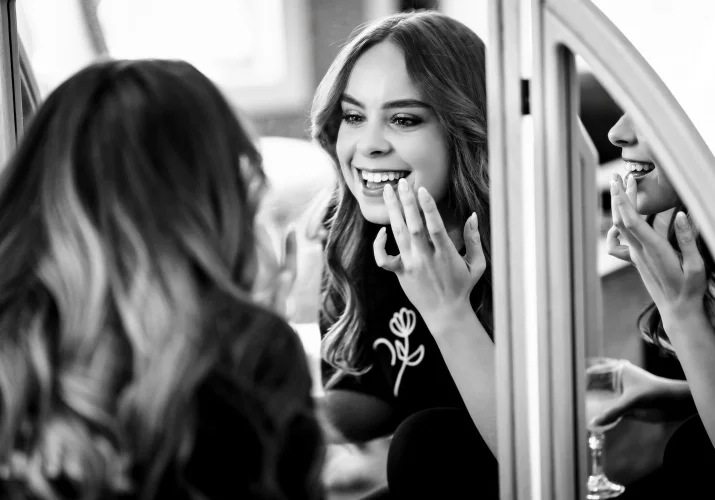 canadian wedding photography of bride putting on lipstick