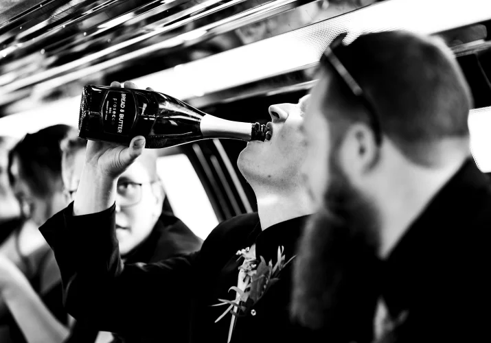 Man drinking champagne out of the bottle
