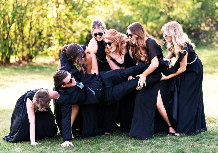 Calgary Bridal Party dropping the groom on the ground