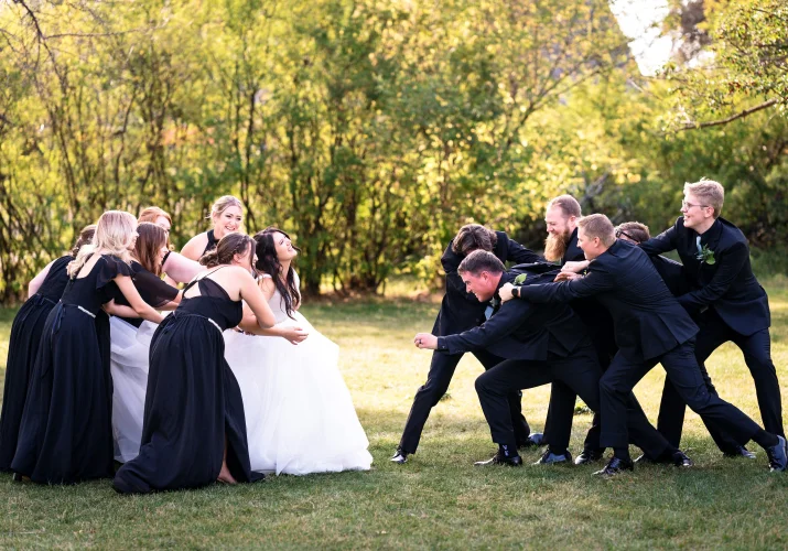 Canadian Wedding Party pulling out the groom and bride away from each other