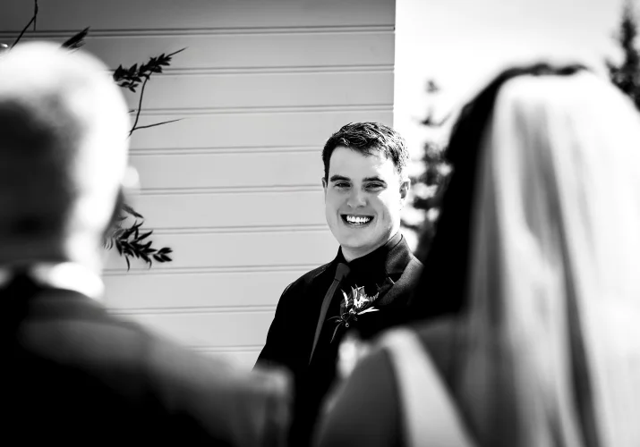 Black and white wedding photography of the groom's first look