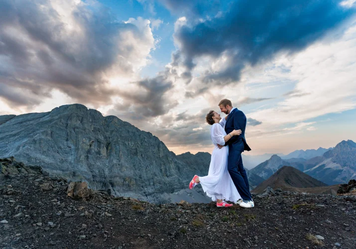 Bride and groom facing each other and look into their eyes during stunning sunset in Banff