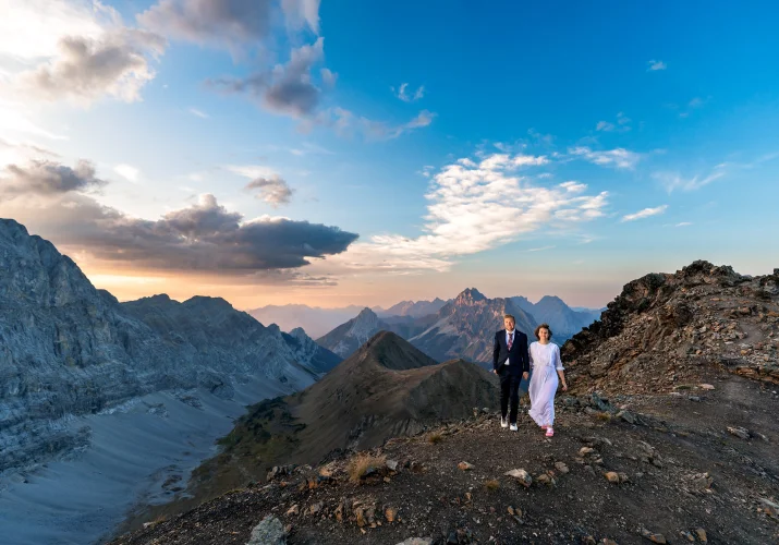 Adventure Wedding Photography of the newlyweds walking on the rigde of the mountain