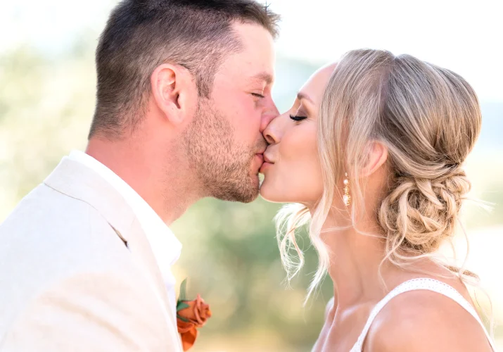 Bride and groom share a kiss.