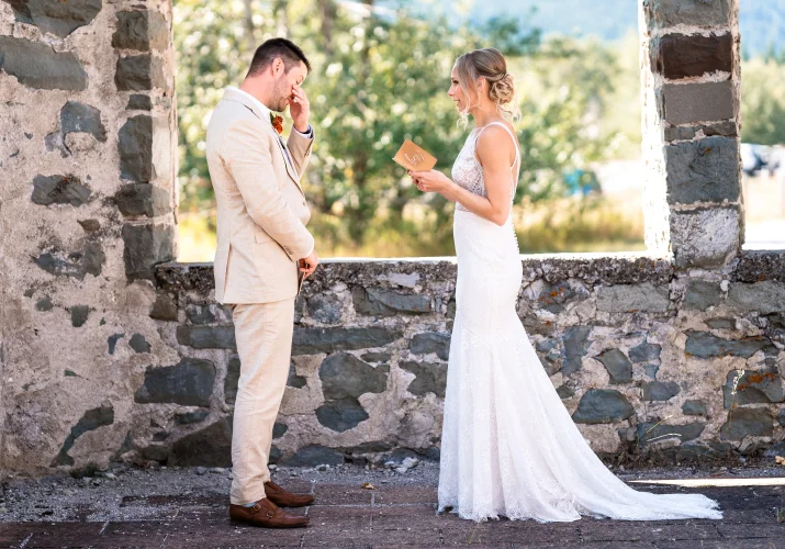 The bride reads her vowes while the groom cries.
