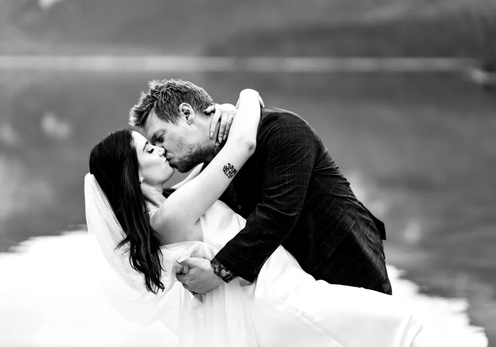 Bride and groom share a kiss.