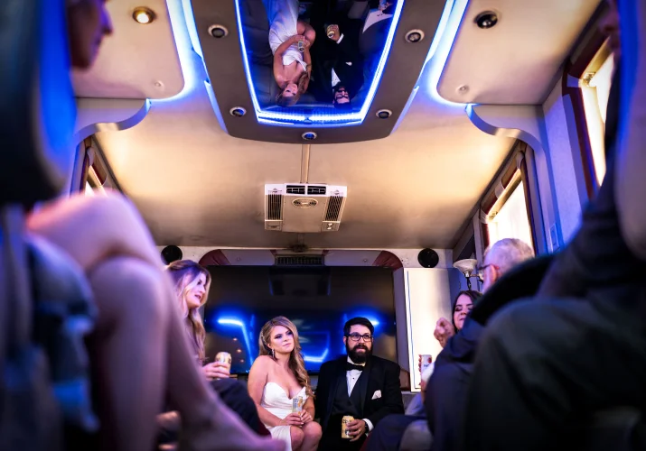 bride and groom in the limo with their reflection on the ceiling