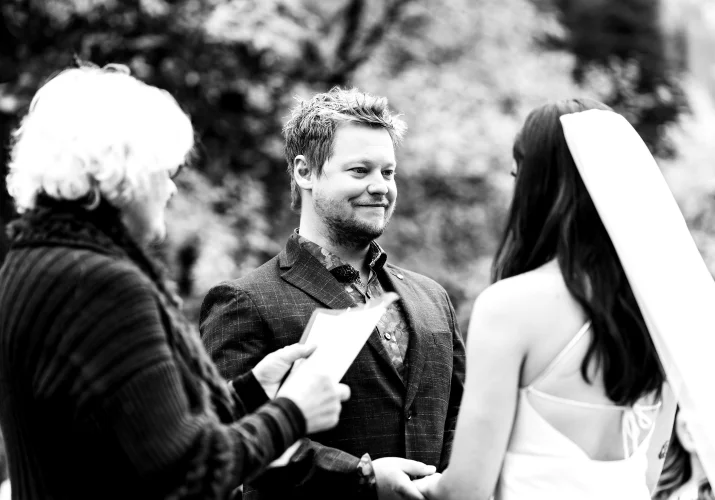 Candid Photography of the bride and groom holding hands during elopement ceremony in the Canadian Rockies