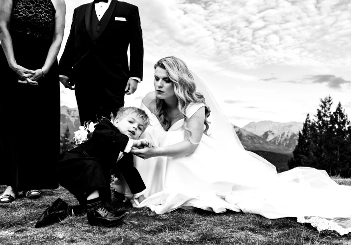 Bride helps her son when he fall to the ground.