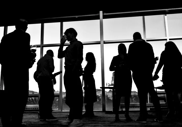 silhouetted wedding guests against the window