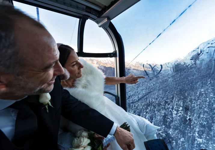 bride draw a heart on the window in the ski lift in Banff
