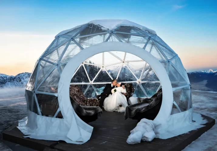 Newlyweds sit in the igloo
