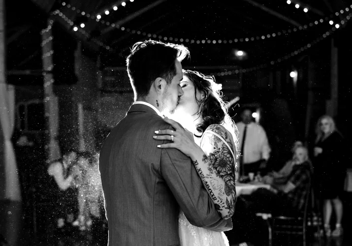 Bride and groom share a kiss during their first dance at the Calgary Wedding Day.