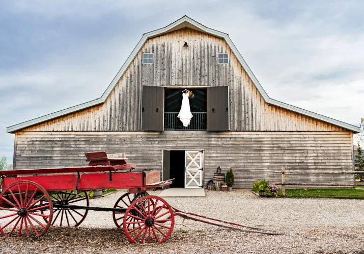 a wedding dress hanging in the sheds window on the Canadian farm in Calgary