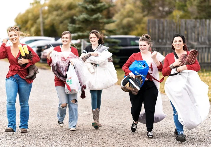 Bridal Party Walking and caring a wedding dress before wedding in Calgary