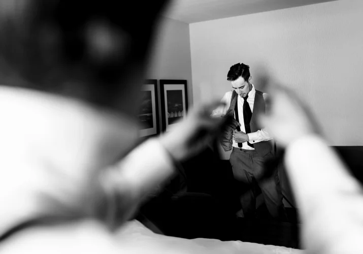 best-man reaches his hands towards the groom
