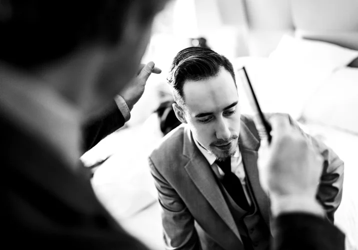 Groom is getting his hair done by the Calgary hair dresser