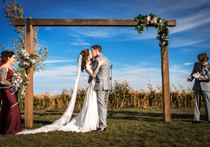 Newlyweds share a kiss. Moment captured by Calgary Wedding Photographer.
