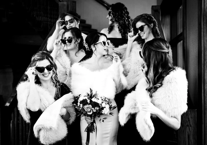 Fun wedding party in Canmore of the bride and bridesmaid wearing sunglasses