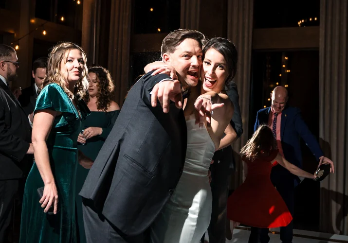 bride and groom point their fingers an the Canmore Wedding Photographer