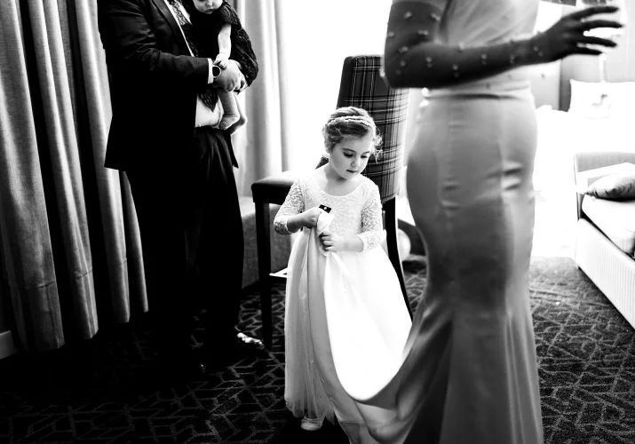 Flower girl fixes the brides wedding dress in Canmore